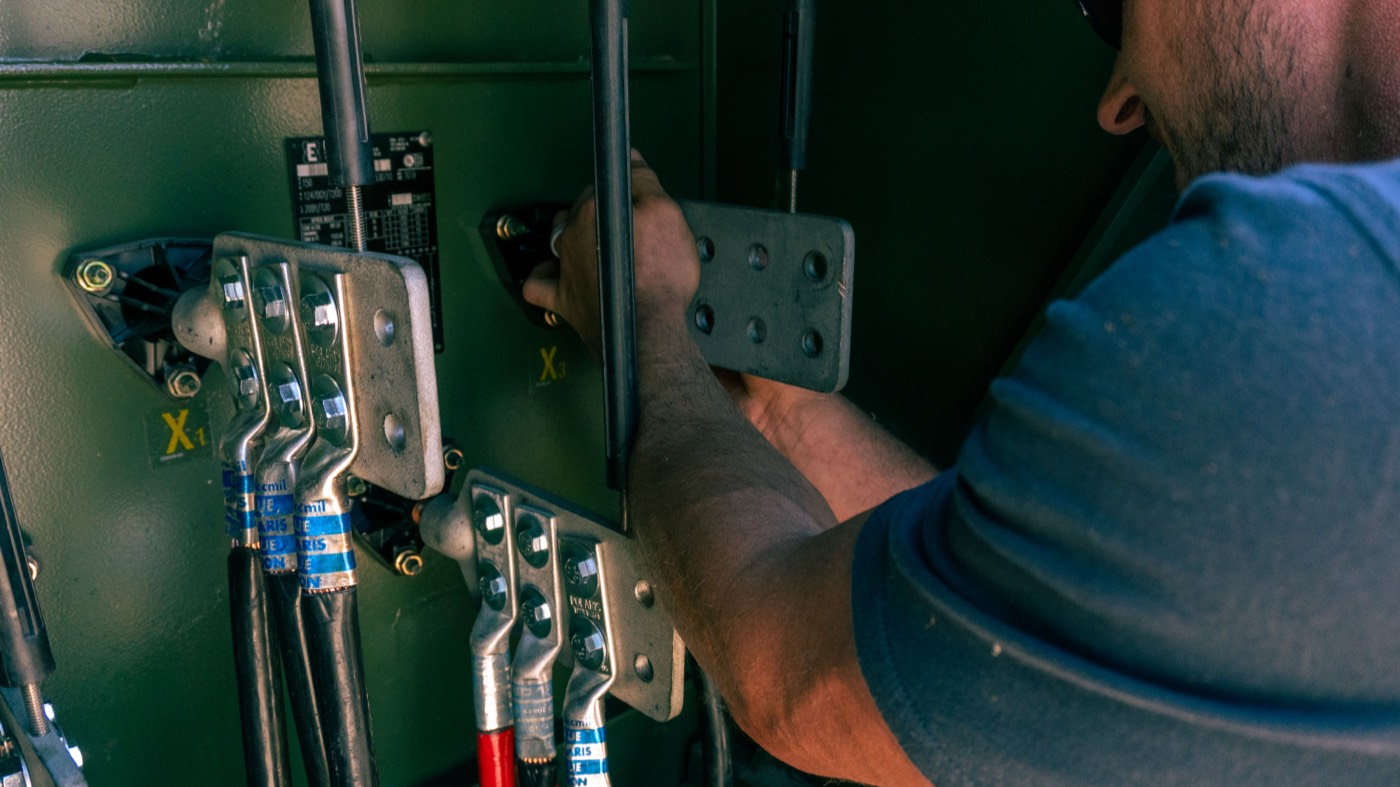Electrician connecting switchgear cabling